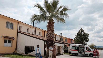 les structures tenues par des organisations religieuses, et les hôtels ou résidences reconvertis en centre d'accueil, l'Italie héberge plus de 80.000 personnes.  (AFP/Alberto Pizzoli )