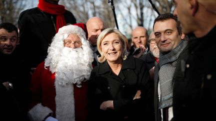 Marine Le Pen et Florian Philippot posent avec un père Noël, à Paris le 8 décembre 2016. (BENOIT TESSIER / REUTERS)