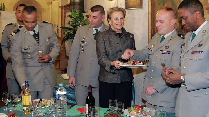 La ministre de la D&eacute;fense Mich&egrave;le Alliot-Marie offre du&nbsp;boudin &agrave; des l&eacute;gionnaires, le 23 d&eacute;cembre 2005, au fort de Nogent-sur-Marne (Val-de-Marne), lors de sa visite de la cr&egrave;che de la l&eacute;gion. (JACK GUEZ / AFP)