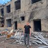 Alexandre Koulik stands in front of the building targeted by Russian strikes on May 2 and 10, 2024. Eight children were injured there while they were upstairs.  (VIRGINIE PIRONON / FRANCEINFO)