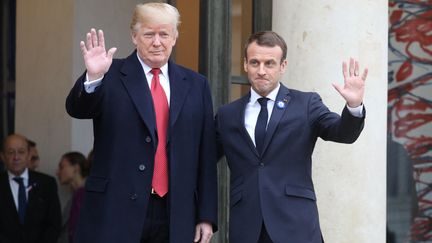 Donald Trump et Emmanuel Macron saluent les photographes, le 10 novebre 2018, sur le perron de l'Elysée, à Paris. (LUDOVIC MARIN / AFP)