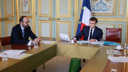 Edouard Philippe et Emmanuel Macron à l'Elysée, le 19 mars 2020. (LUDOVIC MARIN / AFP)