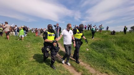 Des policiers suédois arrêtent un manifestant contre les restrictions sanitaires contre le Covid-19 à Stockholm le 6 juin 2021. (ATILA ALTUNTAS / ANADOLU AGENCY)