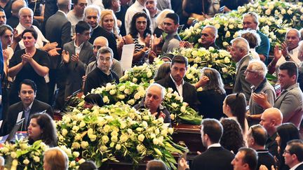 Les familles des victimes de l'effondrement du pont à Gênes se rassemblent près du cercueil de leur proche avant le début de la cérémonie d'hommage, le 18 août 2018. (ANDREA LEONI / AFP)