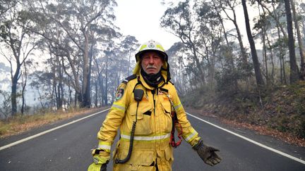 Un pompier volontaire surveille les feux de brousse dans la zone résidentielle de Dargan, à 120 kilomètres de Sydney, le 18 décembre 2019.&nbsp; (SAEED KHAN / AFP)