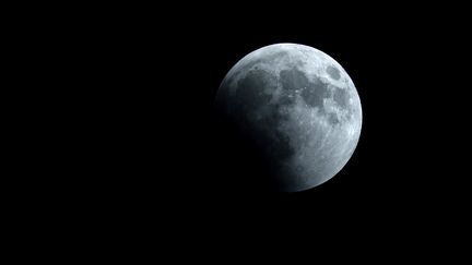 La Lune lors d'une éclipse, le 27 juillet 2018, dans le ciel au-dessus de la ville de Tannourine,&nbsp;au Liban. (JOSEPH EID / AFP)