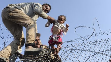 Passage de réfugiés à la frontière turco-syrienne en juin 2015
 (BULENT KILIC / AFP)