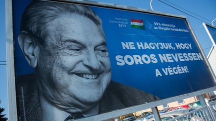 Le gouvernement de droite conservatrice de Viktor Orban a lancé un nouveau volet de sa campagne contre George Soros, américain d'origine juive hongroise, dont le visage mi-rieur, mi-grimaçant a été placardé dans tout le pays, accompagné de la légende&nbsp;"Ne laissez pas Soros&nbsp;rire le dernier". (ATTILA KISBENEDEK / AFP)