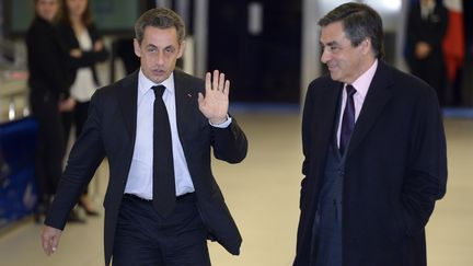 Nicolas Sarkozy et François Fillon après une rencontre au siège de l'UMP à Paris, le 2 décembre 2014. (LIONEL BONAVENTURE / AFP)