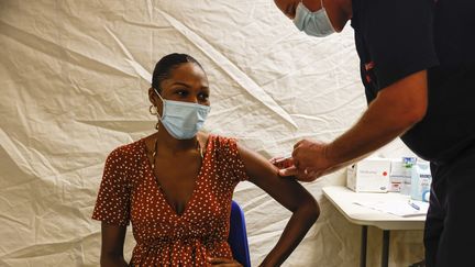 Une femme se fait vacciner au centre de vaccination mis en place au palais des Sports du Lamentin en Martinique, le 2 août 2021. (OLIVIER CORSAN / MAXPPP)