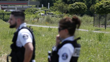 Des policiers devant l'hélicoptère qui a servi à l'évasion de Redoine Faïd, le 1er juillet 2018 à Gonesse (Val-d'Oise). (GEOFFROY VAN DER HASSELT / AFP)