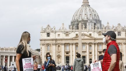 Le Vatican a rouvert ses portes aux touristes et les messes ont repris, dans le respect des distances de sécurité, lundi 18 mai. Près de la place Saint-Pierre, des représentants des commerçants protestent pour réclamer plus d'aides de l'état en faveur de la reprise de leur activité après deux mois de confinement.&nbsp;&nbsp; (RICCARDO DE LUCA / ANADOLU AGENCY / AFP)