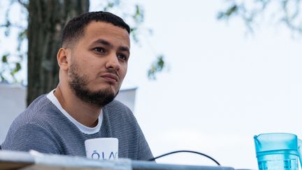 Taha Bouhafs lors du meeting d'été de la France Insoumise (AMFIS), le 17 juillet 2021. (UGO PADOVANI / HANS LUCAS / VIA AFP)