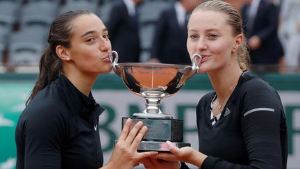 Kristina Mladenovic et Caroline Garcia avec leur coupe de Roland-Garros (THOMAS SAMSON / AFP)