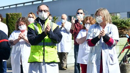 Des membres du personnel soignant de l'hôpital de Compiègne (Oise) participent à un hommage en l'honneur de&nbsp;Jean-Jacques Razafindranazy, médecin décédé des suites du coronavirus, le 23 mars 2020.&nbsp; (RICHARD DUGOVIC / AFP)