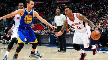 Jeff Teague des Atlanta Hawks face à Stephen Curry des Golden State Warriors