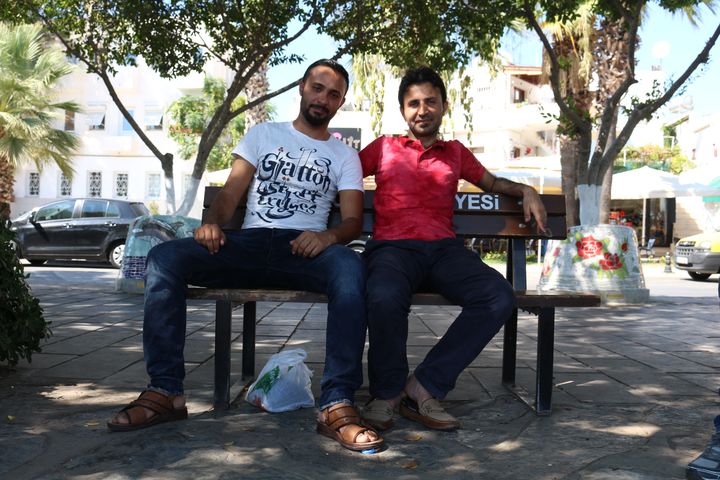 Ayman (&agrave; droite) et son fr&egrave;re Sami, migrants syriens, sont assis sur un banc au bord du port de Bodrum (Turquie), le 21 ao&ucirc;t 2015. (BENOIT ZAGDOUN / FRANCETV INFO)