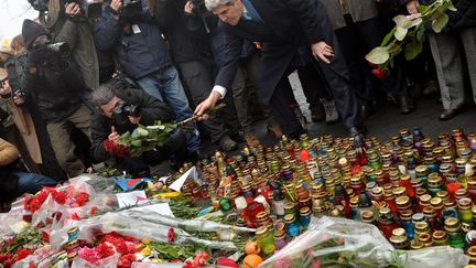 Le secr&eacute;taire d'Etat am&eacute;ricain John Kerry d&eacute;pose une rose au m&eacute;morial des victimes des affrontements &agrave; Kiev (Ukraine), le 4 mars 2014. (SERGEI SUPINSKY / AFP)