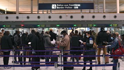 Des voyageurs font la queue devant le bureau de l'immigration de l'aéroport international Roissy-Charles-de-Gaulle,&nbsp;le 1er février 2021. (CHRISTOPHE ARCHAMBAULT / AFP)