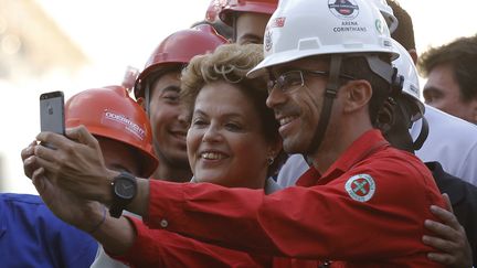 Des ouvriers br&eacute;siliens font un selfie avec leur pr&eacute;sidente, Dilma Rousseff, le 8 mai 2014, &agrave; Sao Paulo. (NACHO DOCE / REUTERS)