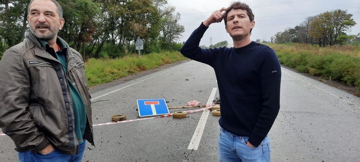 Boris Loumagne with his fixer, Yashar Fazylov, in front of a mined road in Ukraine.   (BORIS LOUMAGNE / RADIO FRANCE)