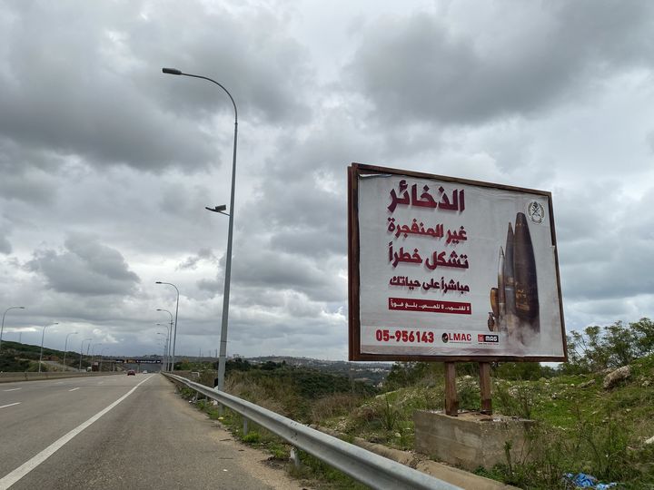 Sur la route qui mène à Tyr, dans le sud du Liban, des panneaux demandent à la population de signaler la présence d'éventuels obus. (RAPHAEL GODET / FRANCEINFO)