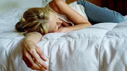 Une femme dort sur un lit. (FR?D?RIC CIROU / MAXPPP)