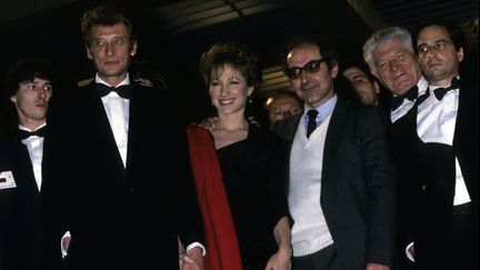 Johnny Hallyday, Nathalie Baye et Jean-Luc Godard (de gauche à droite) au festival de Cannes pour la présentation film "Dètective", en mai 1985. (JEAN-LOUIS URLI / GAMMA-RAPHO)