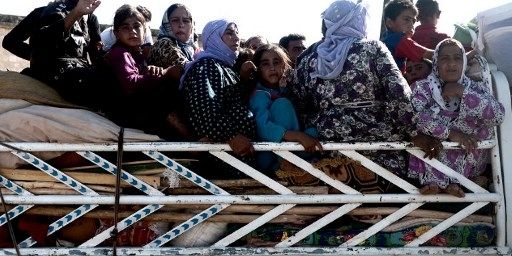 Des réfugiés près de la ville d'Afrin, à la frontière entre la Syrie et la Turquie, le 23 Août 2012. Ces femmes ont fui les combats qui font rage à Alep. (AFP PHOTO / ARIS MESSINIS)