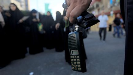 A Hezbollah member holds a wireless communication device with its battery removed after a wireless communication device exploded during a funeral, in Beirut, Lebanon, September 18, 2024. (BILAL JAWICH/XINHUA)