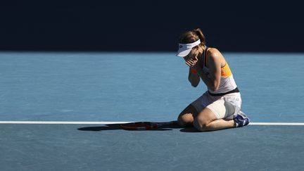 Alizé Cornet tombée à genou après avoir décroché la qualification pour les quarts de finale de l'Open d'Australie le 24 janvier 2022. (MARTIN KEEP / AFP)