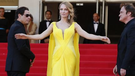 L'équipe du film "Pulp Fiction" à Cannes : John Travolta, Uma Thurman et Quentin Tarantino.
 (AFP / VALERY HACHE)