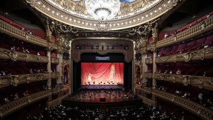 Des spectateurs attendent le début d'un concert spécial donné par l'Opéra de Paris à l'attention des sponsors et le personnel de la santé le&nbsp;13 juillet 2020. (ANNE-CHRISTINE POUJOULAT / AFP)