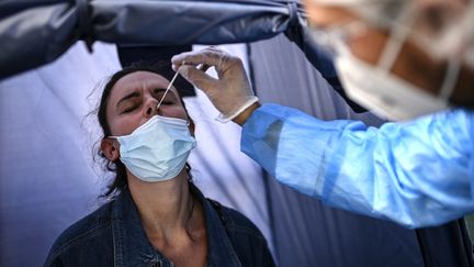 Une femme testée pour le Covid-19 dans un laboratoire à Paris, le 4 septembre 2020. (CHRISTOPHE ARCHAMBAULT / AFP)