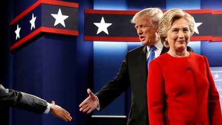 Donald Trump et Hillary Clinton se saluent après le premier débat qui les a opposés, le 26 septembre 2016, à l'université Hofstra, à Hempstead (Etats-Unis).&nbsp; (JONATHAN ERNST / REUTERS)