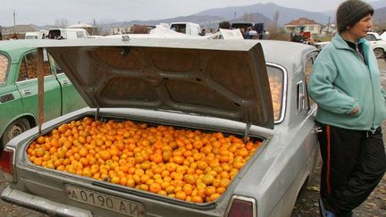 Une Abkhaze vendeuse de mandarines, à la frontière russe. (DENIS SINYAKOV / AFP)