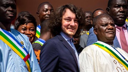 Dmitri Sytyi, le nouveau patron officieux de Wagner en Afrique, entouré de députés centrafricains sur les marches de l'Assemblée nationale à Bangui le 15 octobre 2021. (/ AFP)