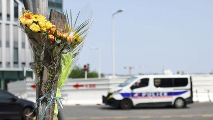 Des fleurs déposées là où s'est encastré le véhicule conduit par Nahel mardi 27 juin. (FRED DUGIT / MAXPPP)