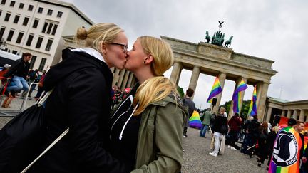 Deux lesbiennes célèbrent l'adoption de la loi allemande autorisant le mariage pour tous, à Berlin (Allemagne), le 30 juin 2017. (TOBIAS SCHWARZ / AFP)