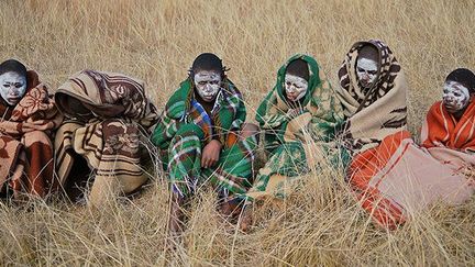 Le 30 juin 2013, près de Qunu, des garçons de la tribu Xhosa viennent d’être circoncis. Ils sont recouverts d’argile blanche et de cendres, enveloppés dans une couverture comme le veut le rituel. Ils sont ensuite envoyés pendant trois ou quatre semaines dans la brousse où leurs aînés leur inculquent le courage et la virilité.  (AFP PHOTO / CARL DE SOUZA)