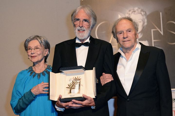 Austrian director Michael Haneke, surrounded by French actors Emmanuelle Riva (left) and Jean-Louis Trintignant (right) pose during a photocall after receiving the Palme d'Or for the film 