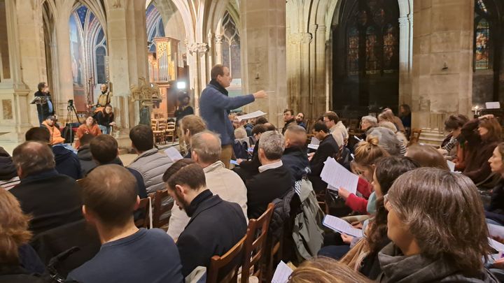 Le chef de chœur Frédéric Pineau lors de l'avant dernière répétition du chœur des compagnons à l'église Saint-Séverin, novembre 2024. (ANNE CHEPEAU / FRANCEINFO / RADIO FRANCE)