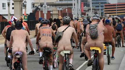 Riders in various states of undress participate in the World Naked Bike Ride in Los Angeles, California on June 22, 2019. - The worldwide event aims to promote bicycles and other non-fossil fuel burning vehicles for transportation, as well as promote body positive values. (Photo by Robyn Beck / AFP) (ROBYN BECK / AFP)