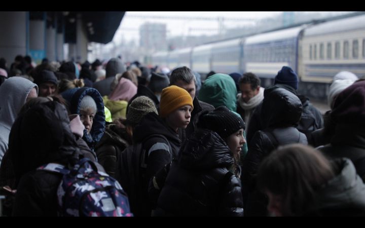 A child waits for a hypothetical train on the crowded platform of kyiv Central Station, March 2, 2022. (FLORIAN LE MOAL / FRANCE TELEVVISIONS)