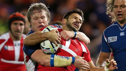 Le joueur géorgien&nbsp;Lasha Malaguradze est plaqué par le Namibien Renaldo Bothma lors du match de Coupe du monde entre les deux équipes, le 7 octobre 2015, à Exeter (Royaume-Uni). (DAVID DAVIES/AP/SIPA / AP)