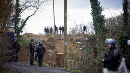 Mobile gendarmes (riot police) stand guard near the ZAD (Zone to Defend) to block access to it in the woods in Saix (Tarn), February 17, 2024. (ALAIN PITTON / NURPHOTO)