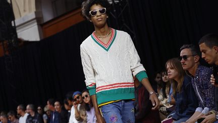 Le Britannique Paul Smith veut rester "extrêmement positif" dans sa collection. Malgré le Brexit, "la vie continue", a lancé le créateur qui a célébré le tartan version rasta : les influences jamaïcaines et les symboles Peace and Love se mêlent aux motifs écossais et aux pulls de cricket. La combinaison de travail est agrémentée d'un col multicolore ou elle est déclinée à carreaux. Tout est fait pour égayer la vie.
 (PATRICK KOVARIK / AFP)