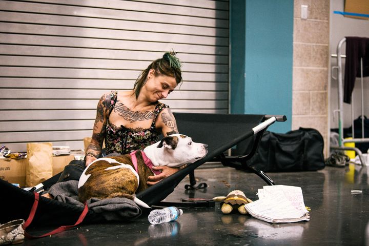 Une habitante de Portland, Christy Wilding, et son chien Birdi, se reposent à la station de refroidissement de l'Oregon Convention Center, à Portland (Oregon, Etats-Unis), le 28 juin 2021. (KATHRYN ELSESSER / AFP)