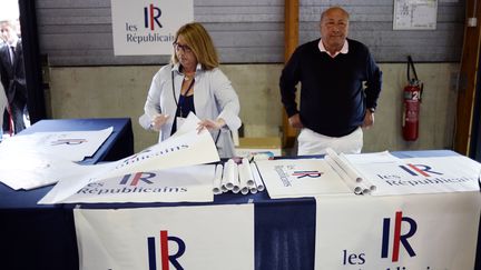 Des membres des R&eacute;publicains vendent l'affiche du nouveau nom et du nouveau logo de l'UMP.&nbsp; (STEPHANE DE SAKUTIN / AFP)