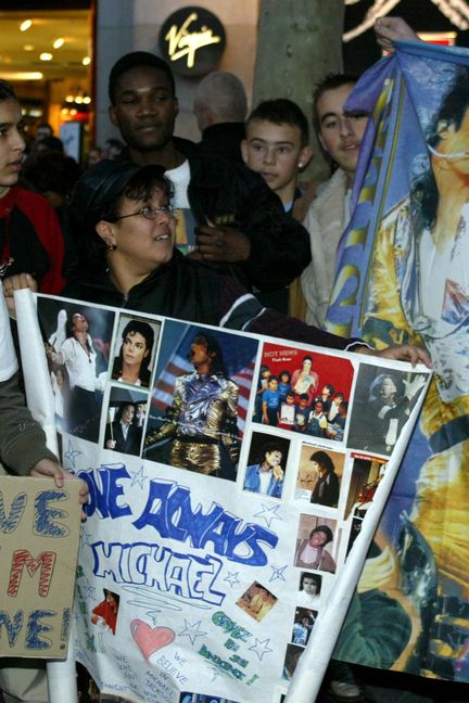 Des fans de Michael Jackson manifestent sur les Champs-Elysées pour soutenir la star, accusée d'agressions sexuelles sur mineur, à Paris, le 22 novembre 2003. (JEAN-LOUP GAUTREAU / AFP)